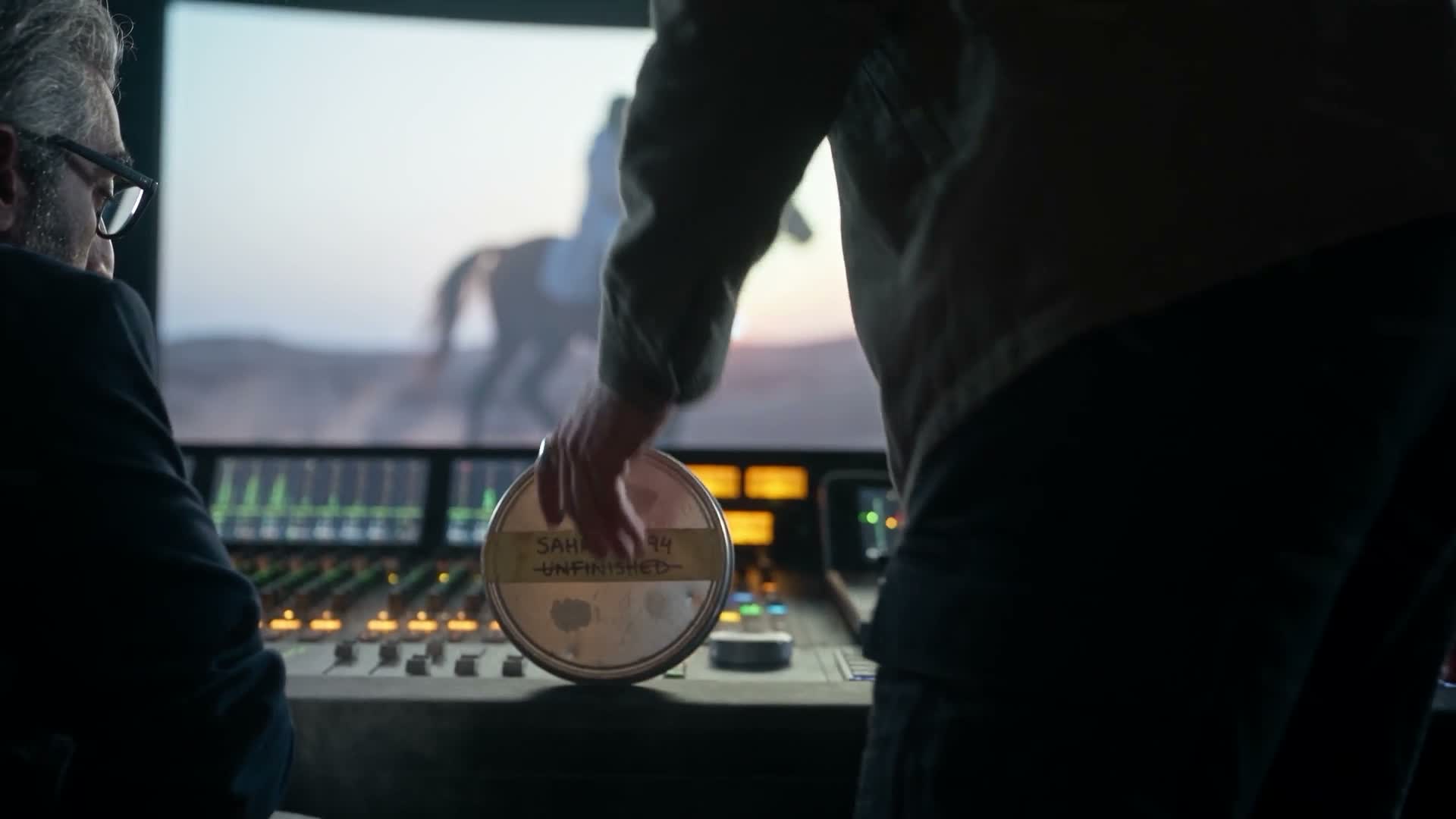 Two characters and a film canister in a recording studio